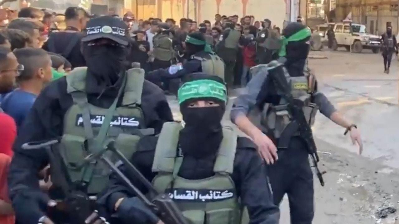 Hamas handover - Masked gunmen pass Israeli hostages to Red Cross *EXCLUSIVE*
