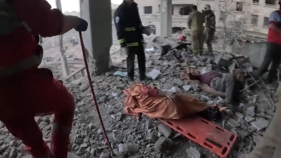 Survival instinct - Rescuers pull two from debris of collapsed building ...