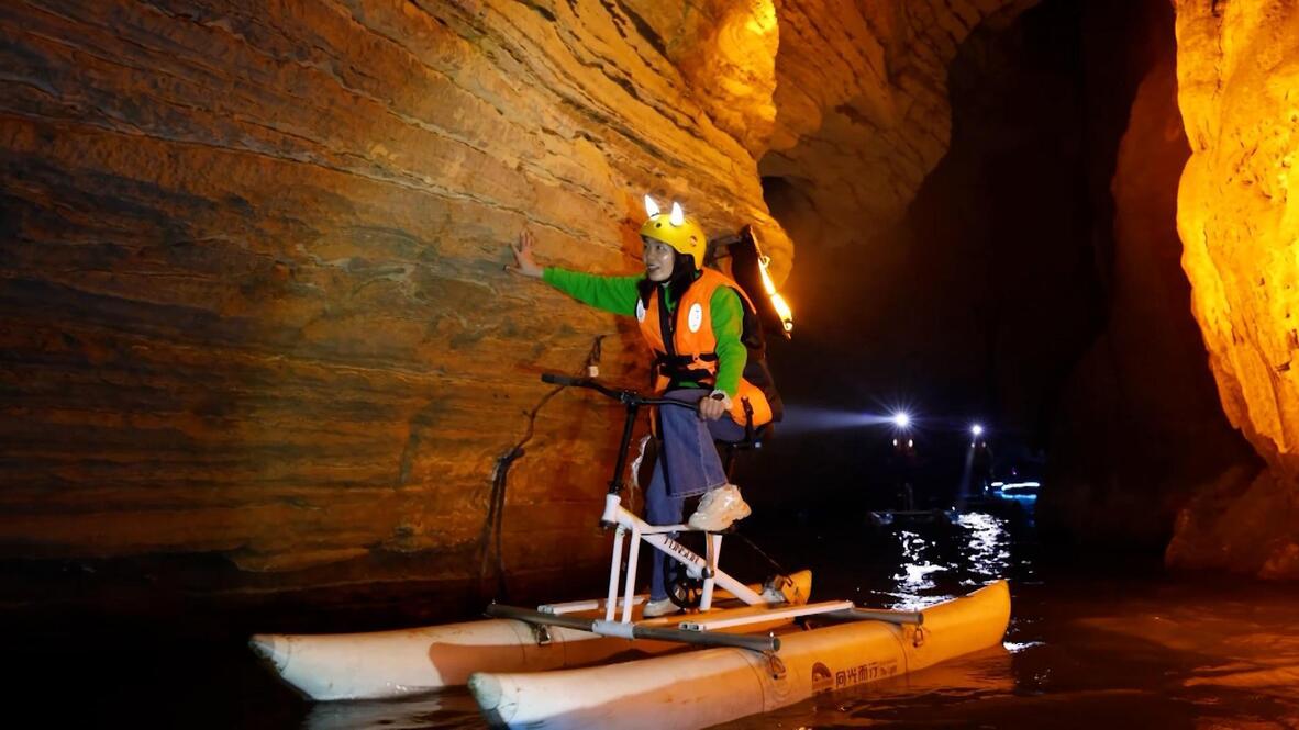 Cave cycling! - Tourists explore Chongqing's glowing karst caverns on ...