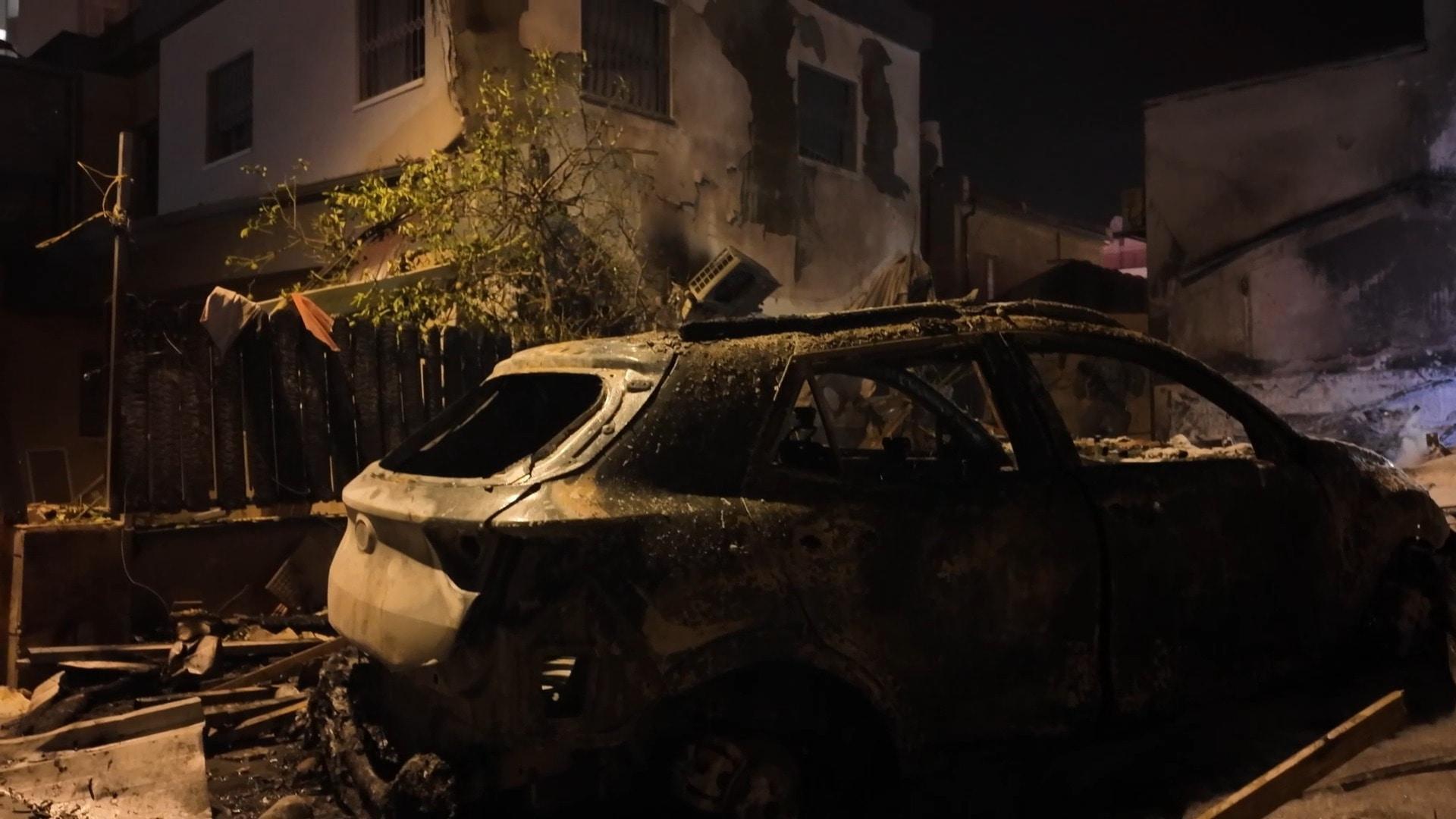 Destruction and devastation - Charred buildings, vehicles after strike ...