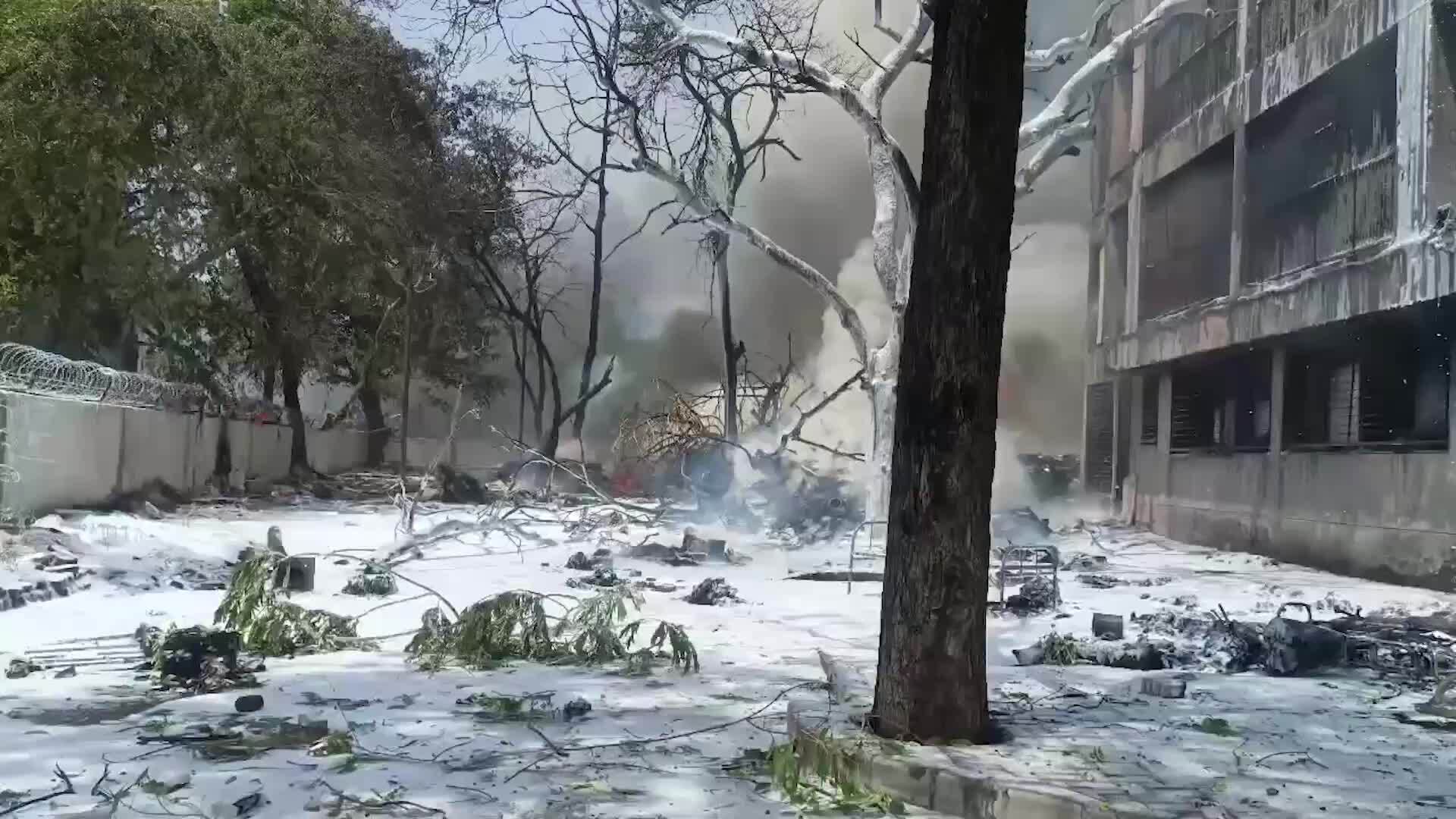 Plane crash aftermath - Ash rains down from scorched building following ...